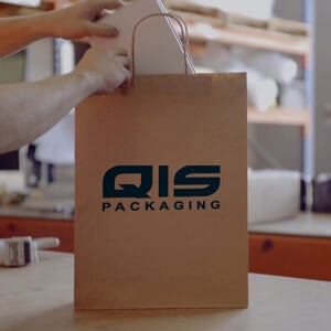Person placing box into QIS bag